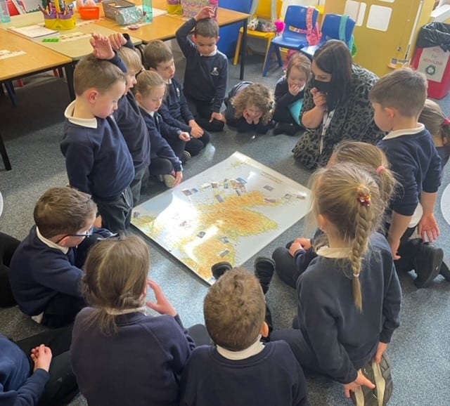 pupils working round a map