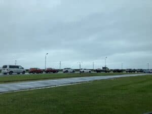 A long line of cars on road along shore front.