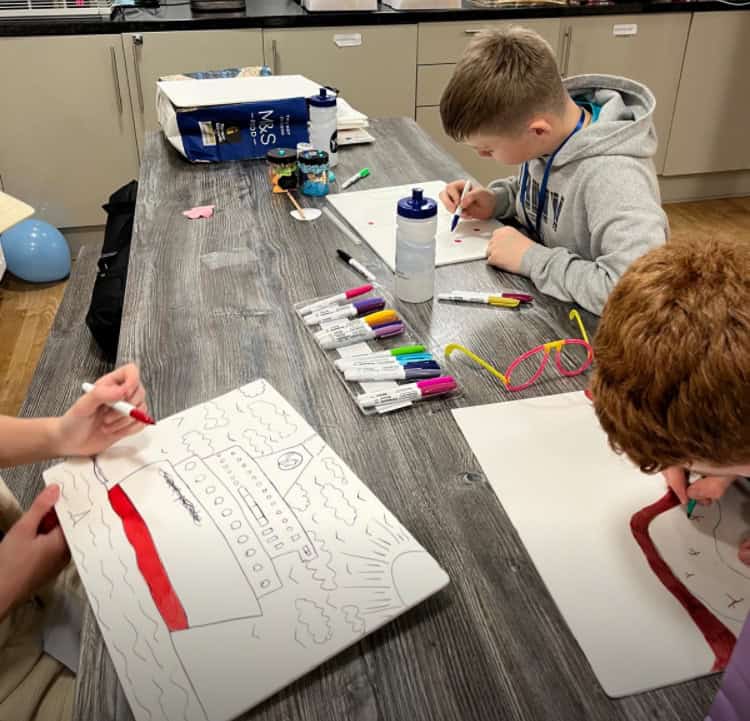 young people drawing at a table