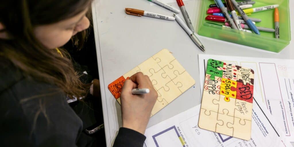 A young person creates a jigsaw featuring some of their happy things.